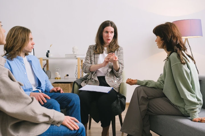 Mental health expert talking to group of person